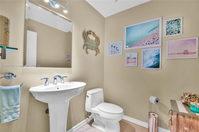 bathroom featuring sink, tile patterned floors, and toilet