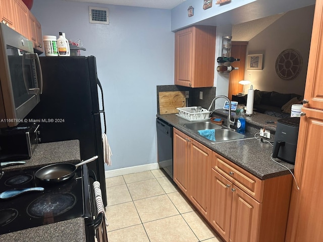 kitchen with black dishwasher, light tile patterned floors, a textured ceiling, sink, and electric range