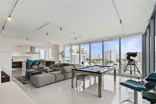 playroom featuring light tile patterned floors, expansive windows, and billiards