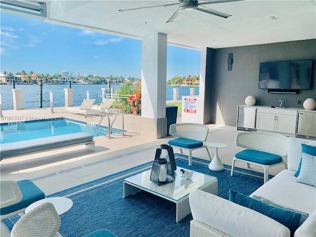 view of pool featuring ceiling fan, a patio area, and sink