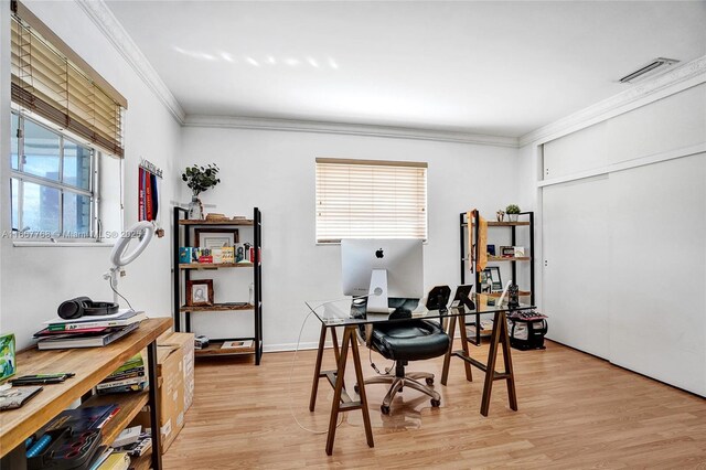 office area with plenty of natural light, crown molding, and light hardwood / wood-style flooring