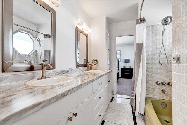 bathroom with tile patterned floors, vanity, shower / bathtub combination with curtain, and a healthy amount of sunlight