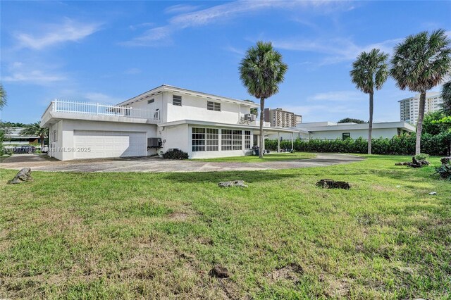 view of front facade with a front yard and a garage