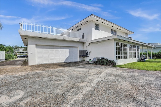 view of home's exterior with a balcony and a garage