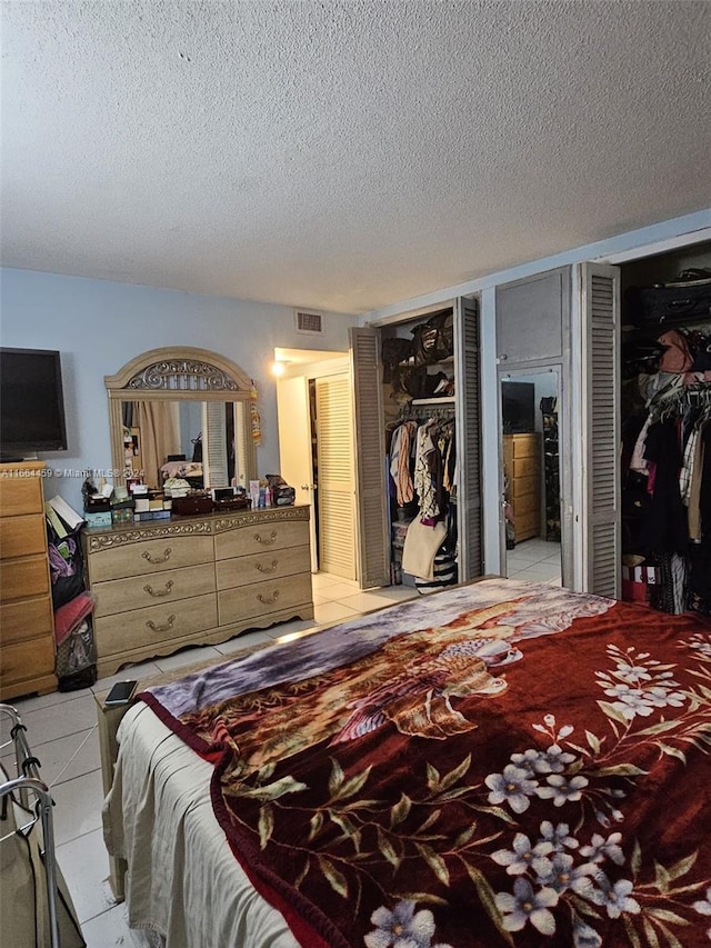 bedroom featuring a textured ceiling and light tile patterned flooring