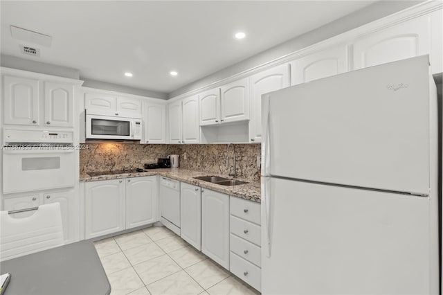 kitchen featuring white cabinets, sink, white appliances, and stone countertops