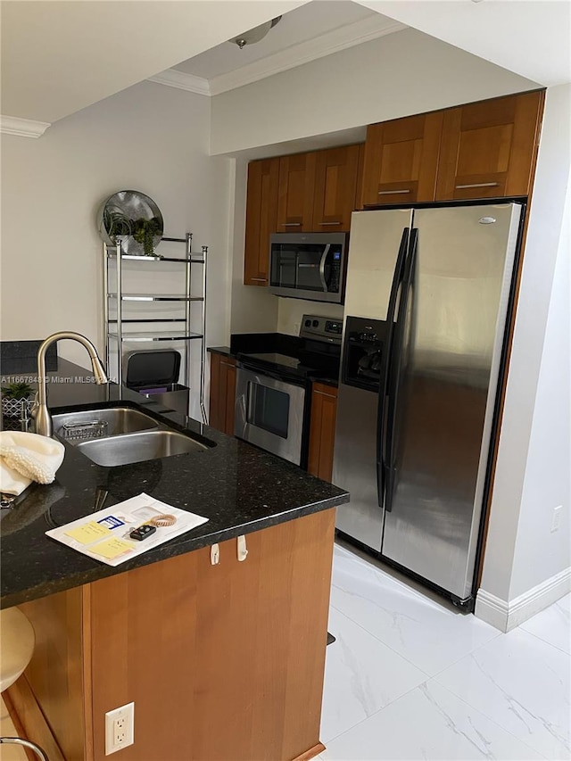 kitchen with appliances with stainless steel finishes, dark stone countertops, a kitchen bar, ornamental molding, and sink