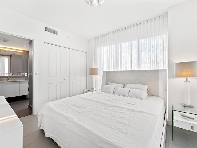 bedroom with sink and a closet