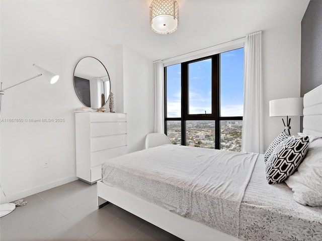 tiled bedroom featuring a wall of windows