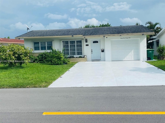 ranch-style home with a front lawn and a garage