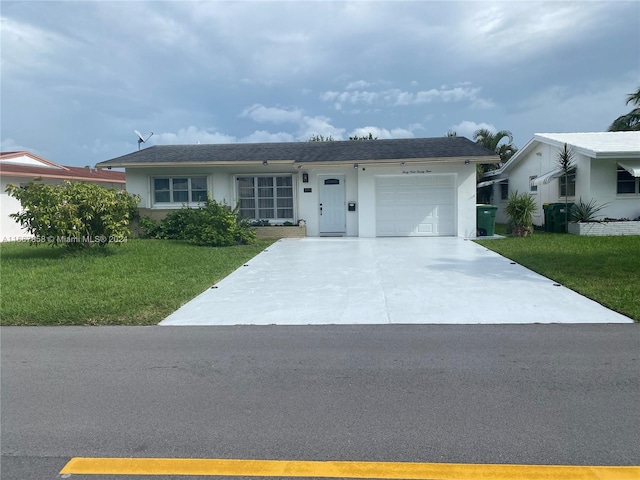 ranch-style home with a garage and a front yard