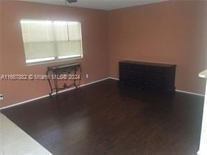 unfurnished living room featuring dark hardwood / wood-style flooring