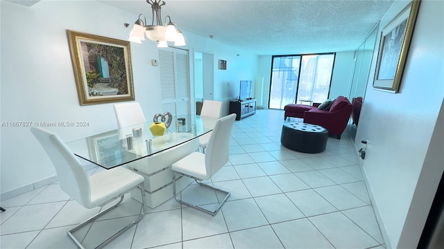 tiled dining space featuring a textured ceiling and a chandelier