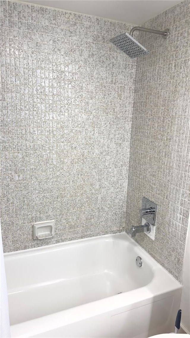 bathroom featuring tiled shower / bath