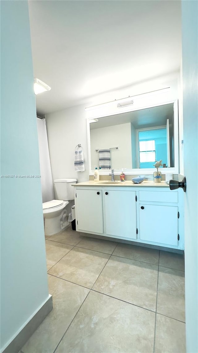 bathroom with tile patterned floors, vanity, and toilet