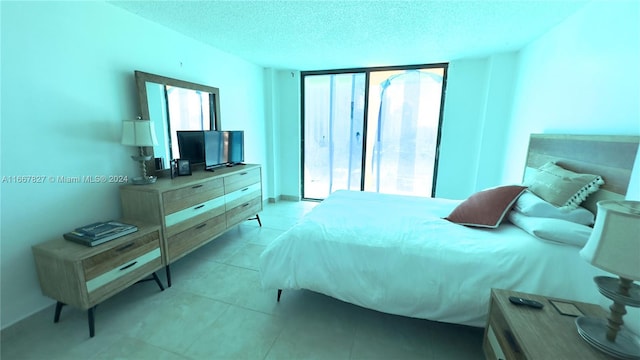 tiled bedroom with a textured ceiling