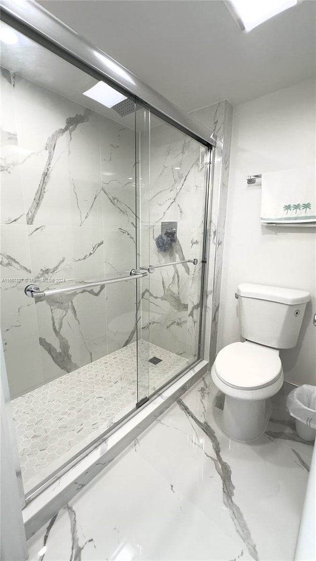 bathroom with walk in shower and toilet