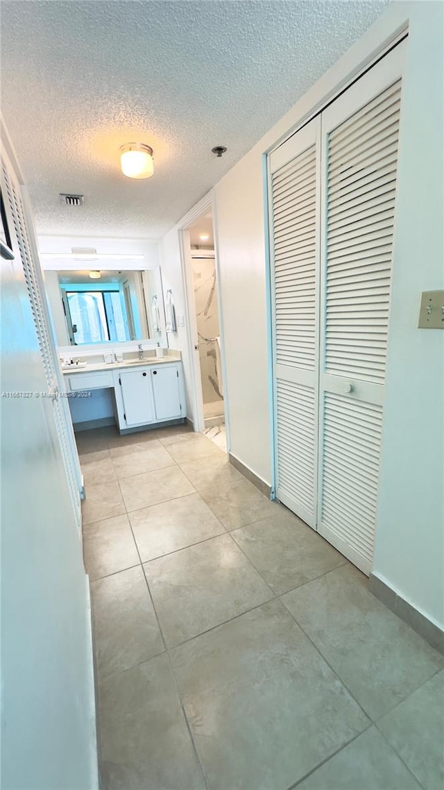 interior space featuring a textured ceiling and vanity