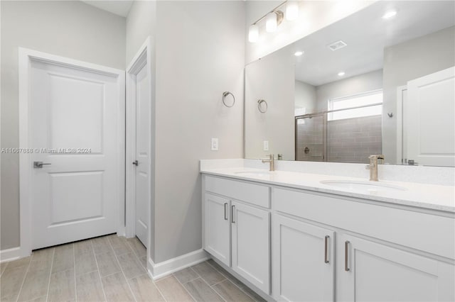 bathroom featuring walk in shower and vanity