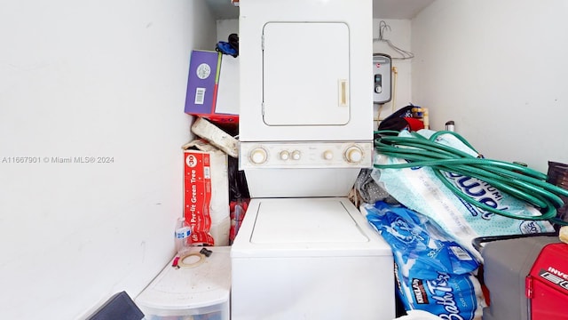 laundry area featuring stacked washer / drying machine