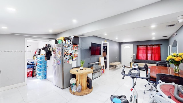 kitchen featuring light tile patterned floors and stainless steel refrigerator