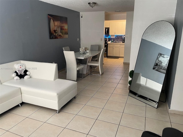 living room with light tile patterned floors and a textured ceiling