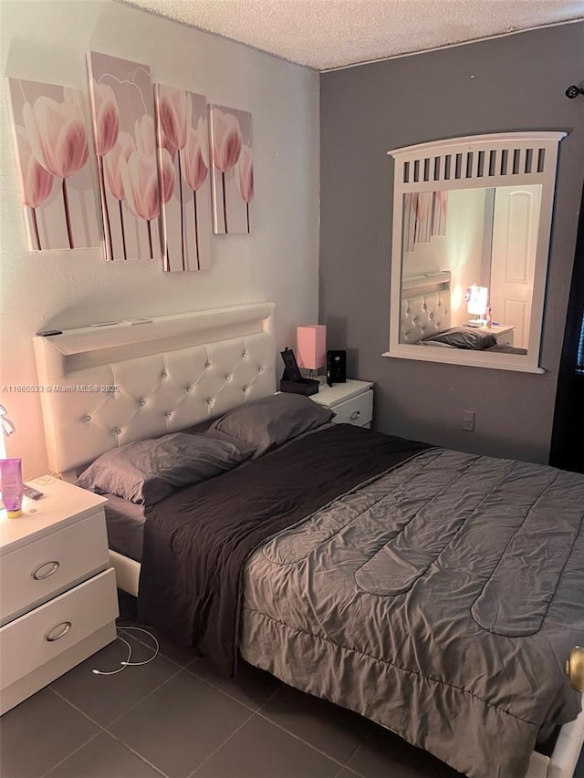 tiled bedroom featuring a textured ceiling