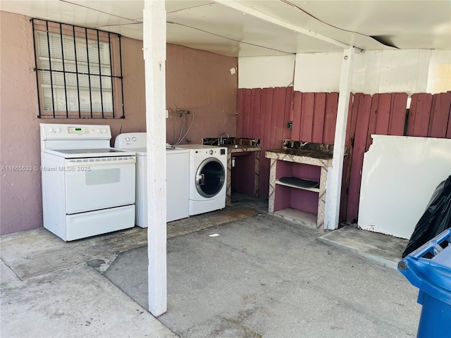 clothes washing area with washer / dryer