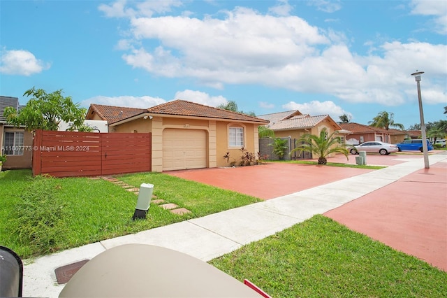 view of front facade featuring a garage and a front yard