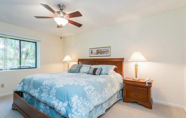 bedroom featuring ceiling fan and light colored carpet