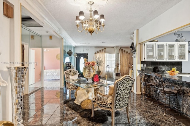 dining room featuring a textured ceiling and an inviting chandelier