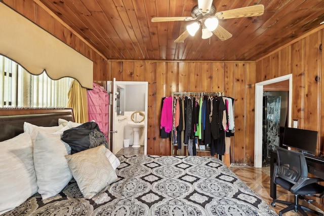 bedroom featuring wooden ceiling, connected bathroom, and wooden walls