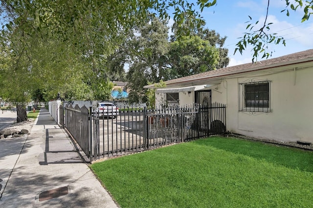exterior space featuring a fenced front yard and a yard