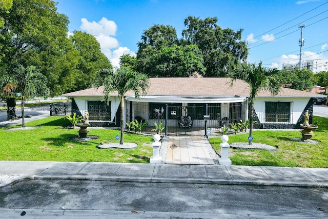 ranch-style house featuring a front lawn, fence, and stucco siding