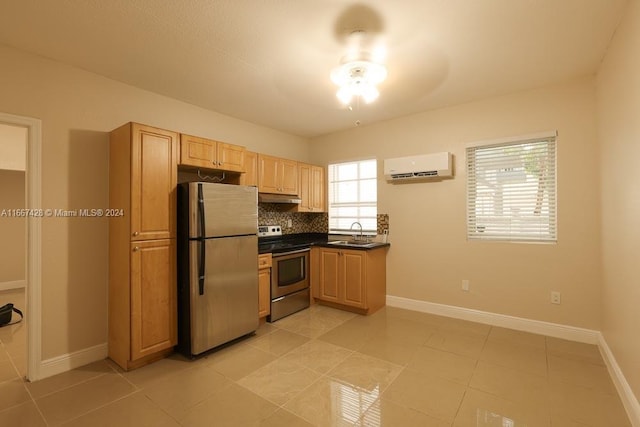 kitchen with sink, light tile patterned floors, tasteful backsplash, appliances with stainless steel finishes, and an AC wall unit