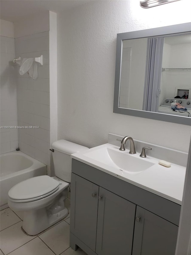 full bathroom with tub / shower combination, tile patterned flooring, vanity, and toilet