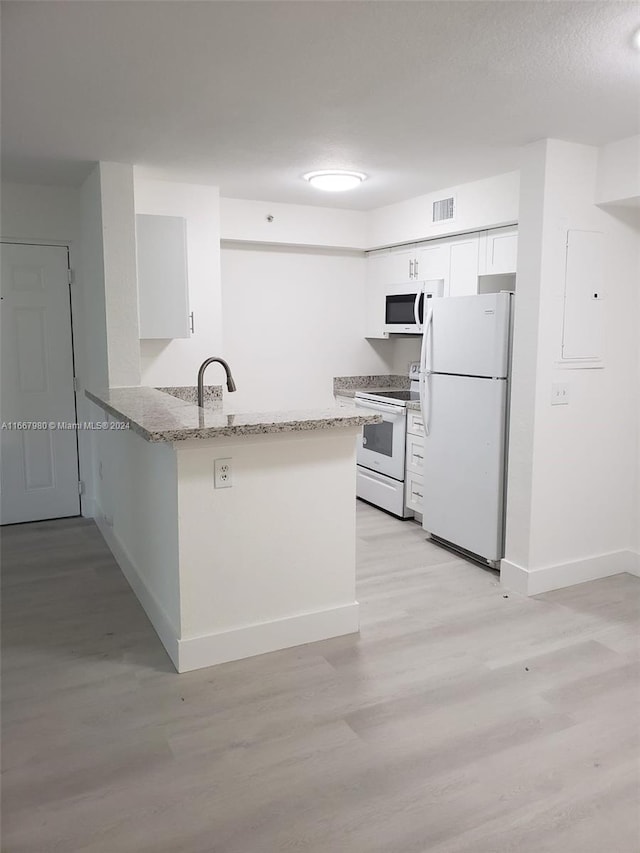 kitchen featuring light stone counters, white cabinets, kitchen peninsula, white appliances, and light wood-type flooring