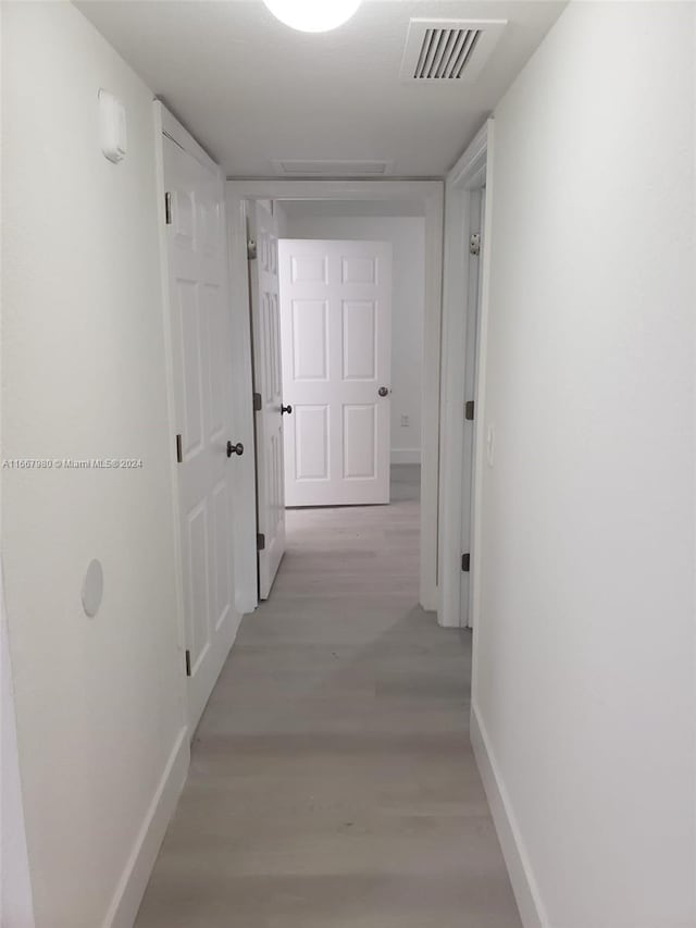 corridor featuring light hardwood / wood-style floors