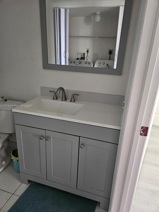 bathroom featuring tile patterned flooring, vanity, and toilet