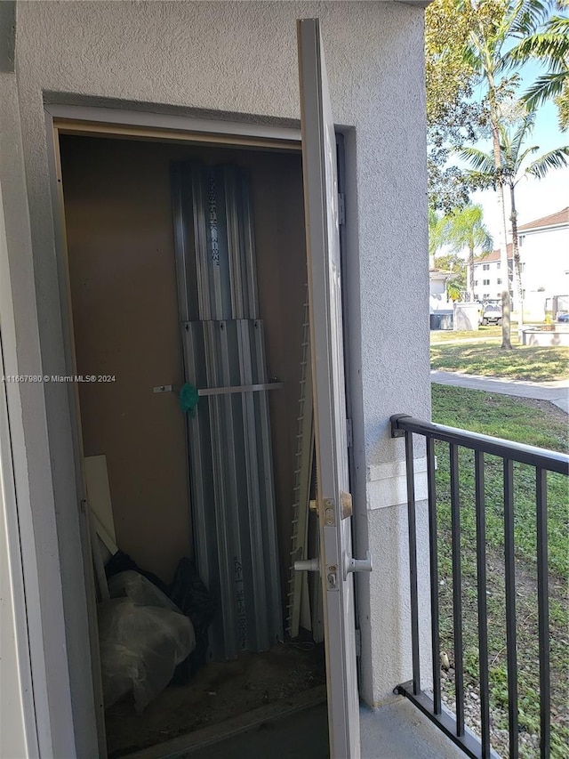 doorway to property featuring stucco siding