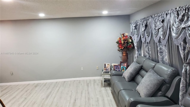 sitting room with a textured ceiling and light hardwood / wood-style floors