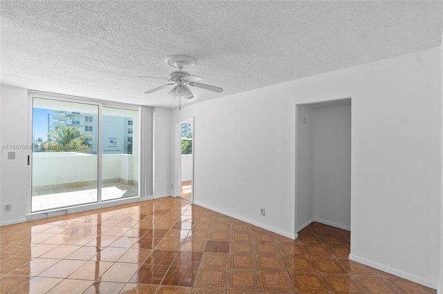 tiled spare room featuring ceiling fan and a textured ceiling