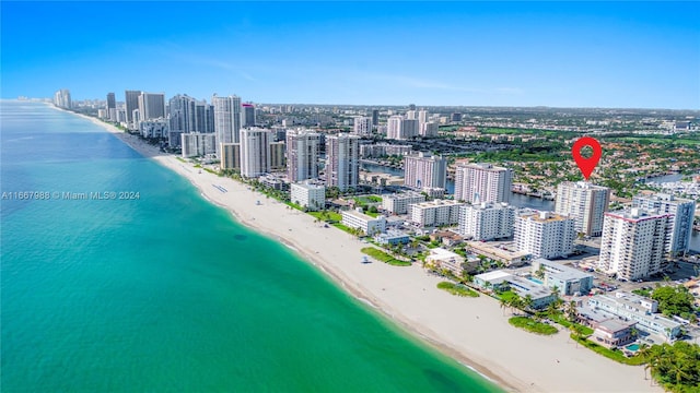 bird's eye view with a water view and a view of the beach