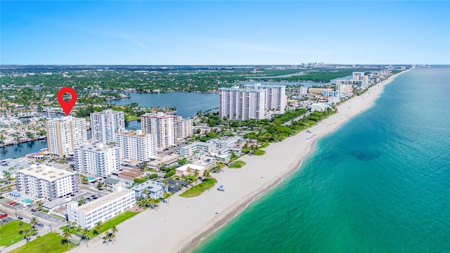 birds eye view of property featuring a beach view and a water view