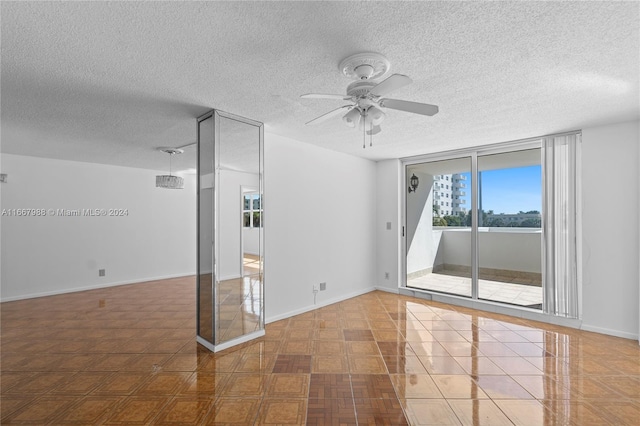 spare room with ceiling fan and a textured ceiling