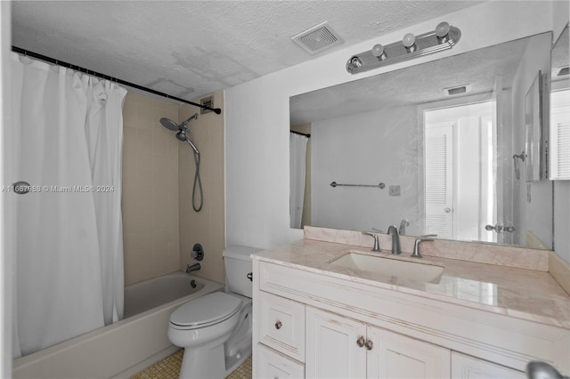 full bathroom featuring vanity, shower / bath combination with curtain, tile patterned floors, toilet, and a textured ceiling