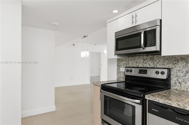 kitchen featuring light tile patterned floors, light stone counters, pendant lighting, white cabinets, and appliances with stainless steel finishes