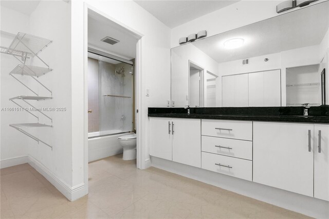 full bathroom with toilet, vanity, and combined bath / shower with glass door