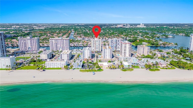 bird's eye view with a water view and a beach view