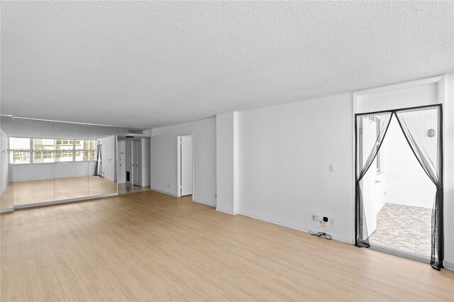 1410 S Ocean Dr Unit 503, Hollywood, FL 33019 - unfurnished living room with light wood finished floors and a textured ceiling